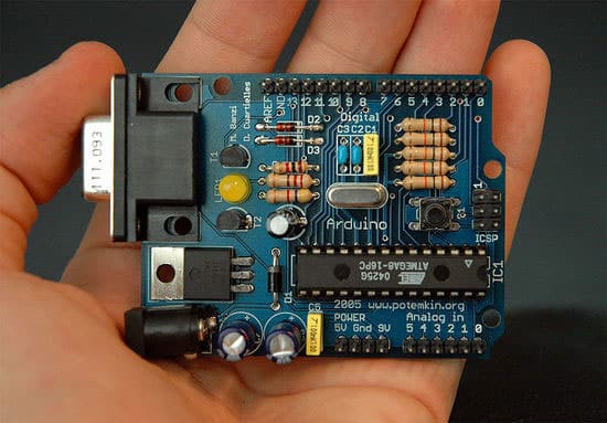 An early Arduino. It uses the RS232 serial interface instead of USB, an ATMEGA8, and male pin headers instead of female. The large black chip at the bottom right of the board is the microcontroller.